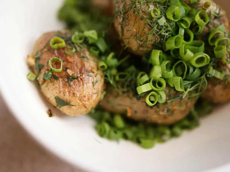 Green potatoes on a cutting board